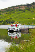 Houseboat with crew at the moorings of Nittel, Dolomitfelsen, Mosel, Germany and Luxembourg, Germany, Luxembourg, Europe