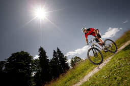 Mountain biker off-roading, Eckbauer, Garmisch-Partenkirchen, Bavaria, Germany