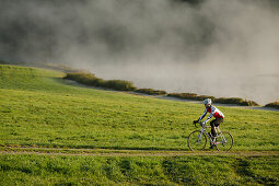 Man cyclocross touring in autumn, Degerndorf, Munsing, Bavaria, Germany