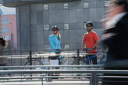 E-bike riders on a bridge, Munich, Bavaria, Germany