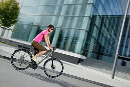 Woman riding an e-bike, Munich, Bavaria, Germany
