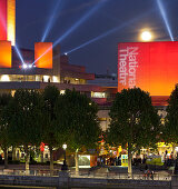 Royal National Theatre with red lights at night, Waterloo Bridge, Bankside, London, England