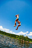 Children jumping into Furtnerteich, Mariahof, Murtal, Styria, Austria