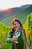 Young woman holding a glass of white wine, Spielfeld, Styria, Austria