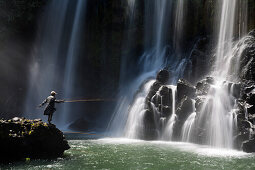 Fisherman at Lily waterfall near the village of Ampefy, Madagascar, Africa