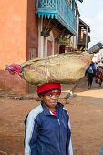 Madagascan boy carrying a turkey on his head, Betsileo tribe, Ambalavao, Fianarantsoa Region, Madagascar, Africa