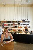 Woman having coffee at Kaufrausch, run by different retailers and designers (Marsbar Cafe by Harald Zachert, leather goods by Volker Lang), Isestrasse 74, Hamburg, Germany