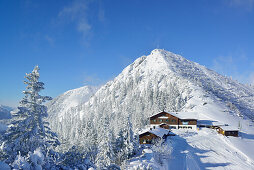 View to snow-covered Herzogstand and Herzogstandhaus, Herzogstand, Bavarian Alps, Upper Bavaria, Bavaria, Germany