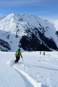 Female backcountry skier downhill skiing, Kleiner Galtenberg, Kitzbuehel Alps, Tyrol, Austria