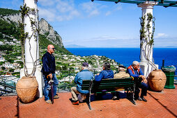 Men sitting on a bench, Piazzetta, Capri, Campania, Italy