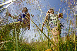 Two female hikers walking the Alpe-Adria-Trail, Nockberge, Carinthia, Austria