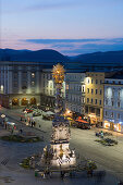 Main square in the evening with the baroque Holy Trinity column, also known as Plague column, Linz, Upper Austria, Austria