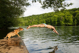 Man jumping into lake Schmaler Luzin, Feldberger Seenlandschaft, Mecklenburg-Western Pomerania, Germany