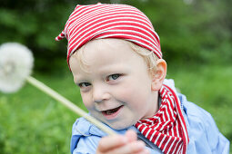 Boy (2 years) holding a blowball, near Blumenholz, Mecklenburg-Western Pomerania, Germany