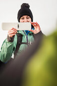 Hiker taking pictures in rural landscape