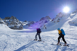 Two female backcountry skiers ascending to Monte Pesco Falcone, Rava del Ferro, Maiella, Abruzzo, Italy