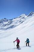 Two female backcountry skiers ascending to Gleirscher Rosskogel, Pforzheim Hut, Sellrain, Stubai Alps, Tyrol, Austria