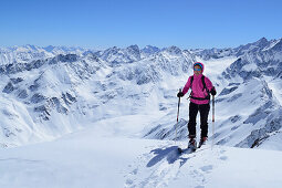 Female backcountry skier ascending to Gleirscher Rosskogel, Pforzheim Hut, Sellrain, Stubai Alps, Tyrol, Austria
