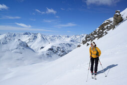 Female backcountry skier ascending to Vallatscha, Sesvenna range, Ofenpass, Grisons, Switzerland