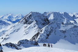 Group of persons back-country skiing ascending over snowface to Weisskugel, Weisskugel, Oetztal range, South Tyrol, Italy