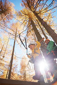 Boy and guide in a high ropes course, Vernagt am See, Schnals Valley, South Tyrol, Italy