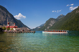 Excursion boat in front of baroque style pilgrimage church St Bartholomae, Koenigssee, Berchtesgaden region, Berchtesgaden National Park, Upper Bavaria, Germany