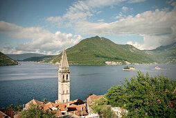 View of Perast with church tower, Island of St. George and Our Lady of the Rock island in the background, Bay of Kotor, Adriatic coastline, Montenegro, Western Balkan, Europe, UNESCO