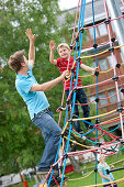 Father and son (7 years) on a climbing frame, Styria, Austria