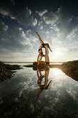 Couple practicing acroyoga at lake Starnberg, Upper Bavaria, Germany