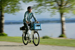 Man cycling with an E-bike along lake Starnberg, Upper Bavaria, Germany