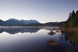Morning mist, view over lake Barmsee to the Karwendel mountains, near Mittenwald, Bavaria, Germany