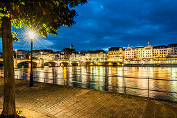 View over the river Rhine with Mittlere Bruecke (Middle Bridge) to a hotel in the evening, Basel, Canton of Basel-Stadt, Switzerland