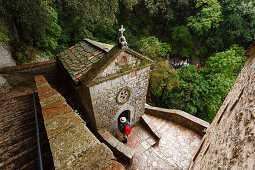 Hiker, pilgrim visiting the chapel Eremo delle Carceri, hermitage above Assisi, Monte Subasio, St. Francis of Assisi, Via Francigena di San Francesco, St. Francis Way, Assisi,  province of Perugia, Umbria, Italy, Europe