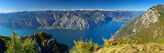 Panorama from Ventrar with view of lake Garda, Limone and Riva and view to Lake Garda range, Adamello range, Presanella range, Brenta range and valley of Sarca, Ventrar, Monte Baldo, Lake Garda range, Trentino, Italy