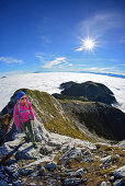 Woman ascending on ridge to Guffert, Brandenberg Alps (Rofan), Tyrol, Austria