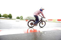 Man riding an electric bicycle on a test track, Tanna, Thuringia, Germany