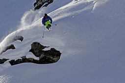 Freeskier jumping down a cliff, Chandolin, Canton of Valais, Switzerland