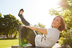 Woman sitting on a bench, Munich, Bavaria, Germany