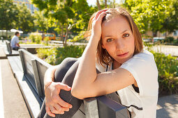 Woman sitting on a bench, Munich, Bavaria, Germany