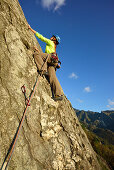 Woman climbing a rock face, Antona, Apuan Alps, Tuskany, Italy