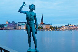 Bronze Statue Sangen in city hall garden and Riddarholmen with Riddarholmen church in the background, Stockholm, Sweden