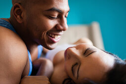 Mid adult couple relaxing on bed