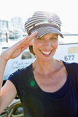 Woman in sailor hat, saluting