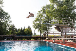 Man jumping from diving board, Leipzig, Saxony, Germany