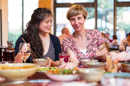 Two women in a Chinese restaurant, Leipzig, Saxony, Germany