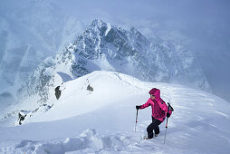 Woman ascending to Piz Zuort, Piz Plavna Dadora in background, Piz Zuort, Sesvenna Alps, Engadin, Graubuenden, Switzerland
