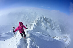 Woman ascending to Piz Zuort, Piz Plavna Dadora in background, Piz Zuort, Sesvenna Alps, Engadin, Graubuenden, Switzerland