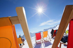 Deck chairs in snow, Zugspitze, Upper Bavaria, Germany