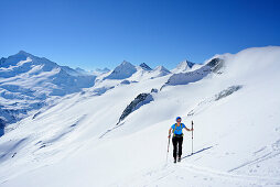 Female back-country skier ascending to Schlieferspitze, Venediger Group, High Tauern National Park, Salzburg, Austria