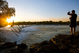 Dam of the Parry Creek Road over the Ord River at sunset with people fishing, Near Kununurra, Western Australia, Australia